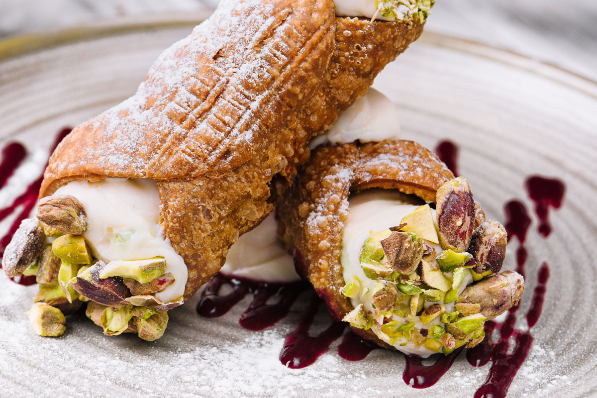 - DiningOut Traditional italian dessert cannoli siciliani on plate