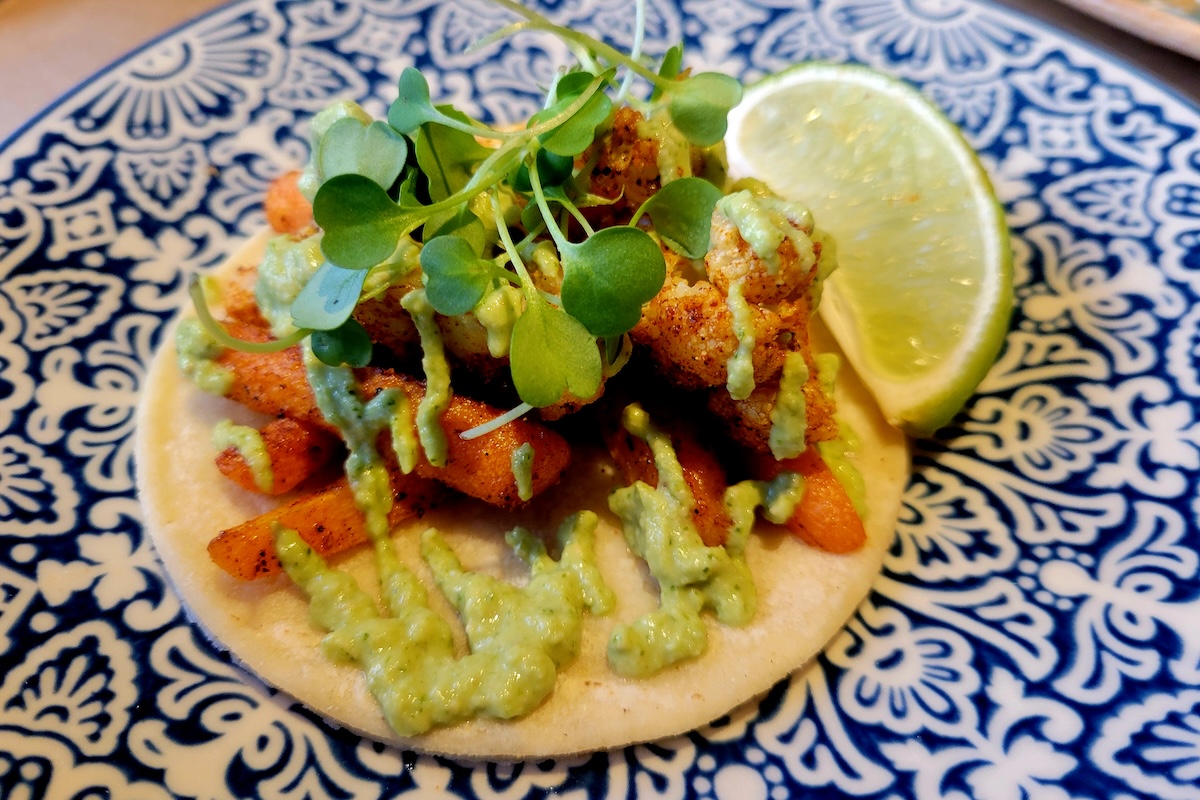 - DiningOut blue and white plate with taco