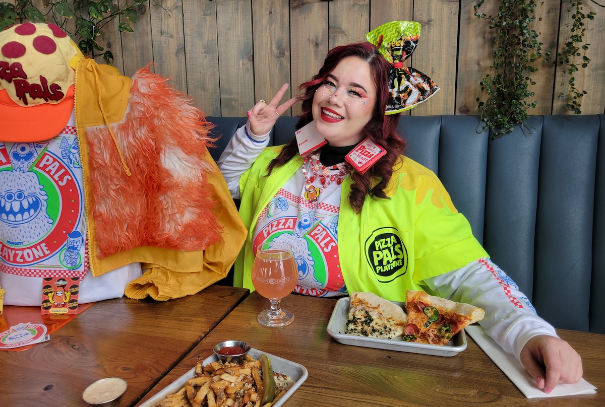 Meow Wolf’s Doja Dozier, mistress of merch and pizza. | Photo by Linnea Covington