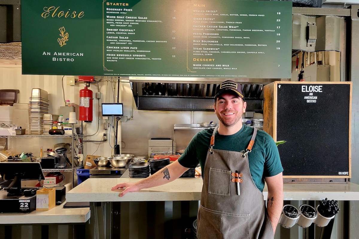 Chef Quincy Cherrett stands in front of his new concept, Eloise American Bistro. | Photo by Linnea Covington