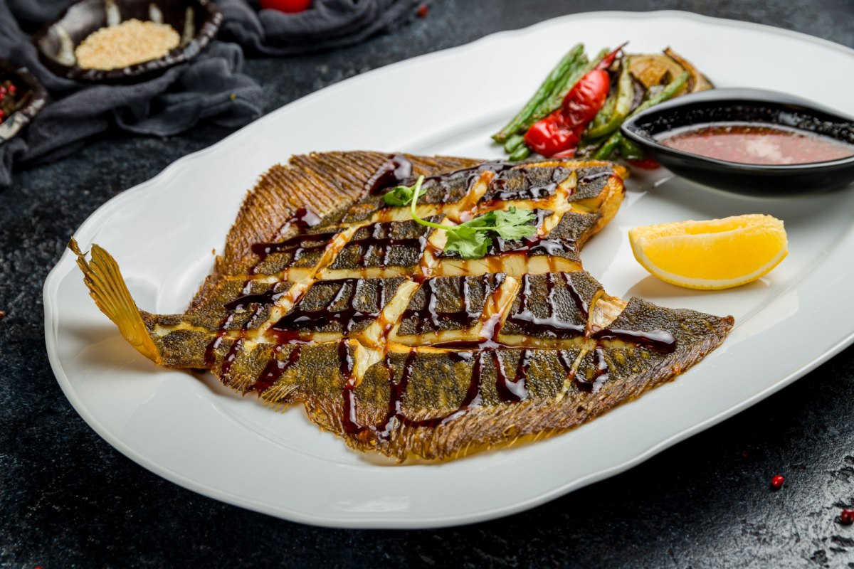 - DiningOut Roasted Snapper, sea red perch fillet on a plate with salad