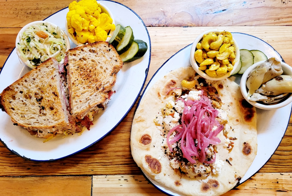 - DiningOut wood table with sandwiches on white plates