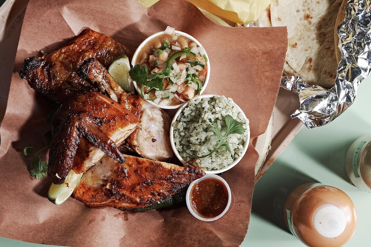 Wood-fire grilled chicken al carbon is the signature dish at Little Rey, served as a half bird with tortillas, beans and rice. | Photo by Andrew Thomas Lee