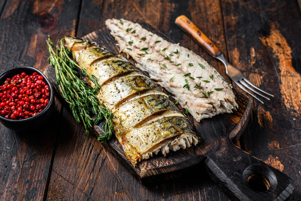 - DiningOut Roasted fillets of mackerel fish on cutting board.
