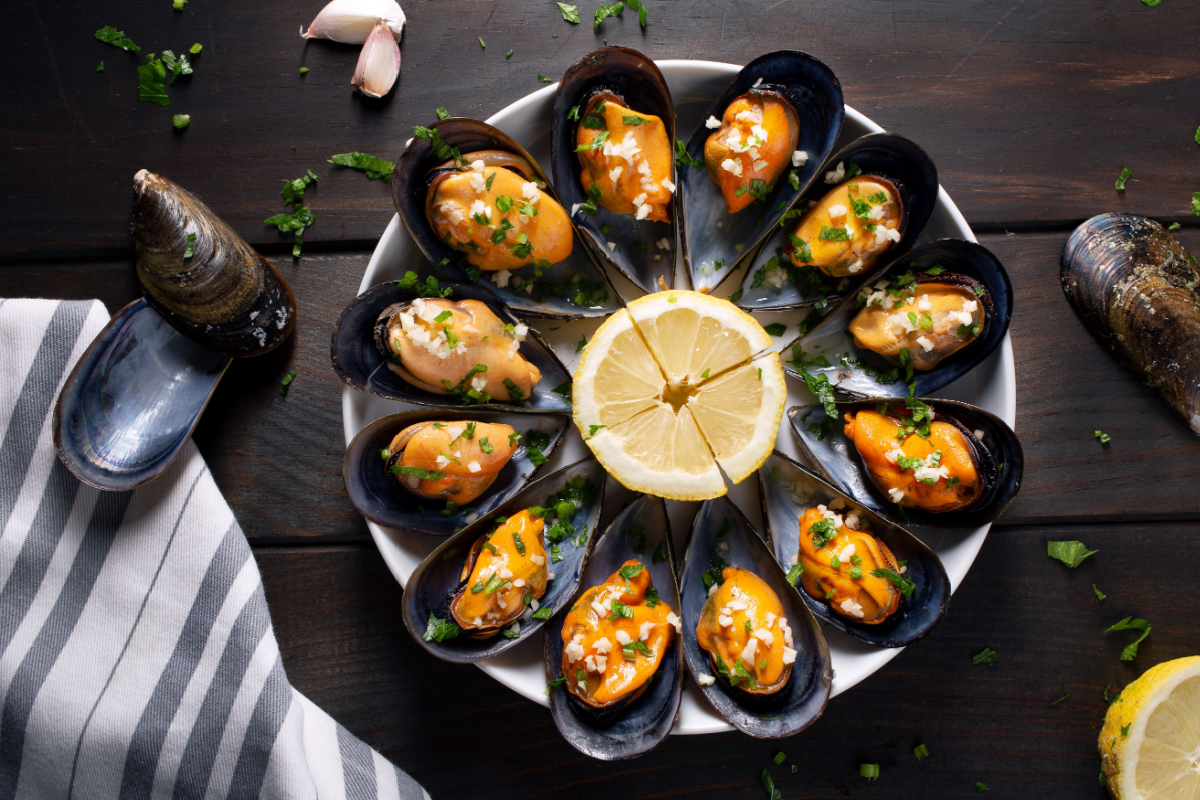 - DiningOut Steamed mussels in white wine sauce with parsley and garlic.