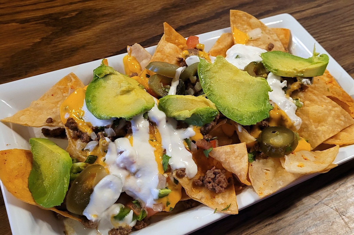 BoriMontrose_FirstFloorDining_EthanMarkYang - DiningOut Order a plate of nachos and enjoy the game on TV. | Photo by Highland Tavern