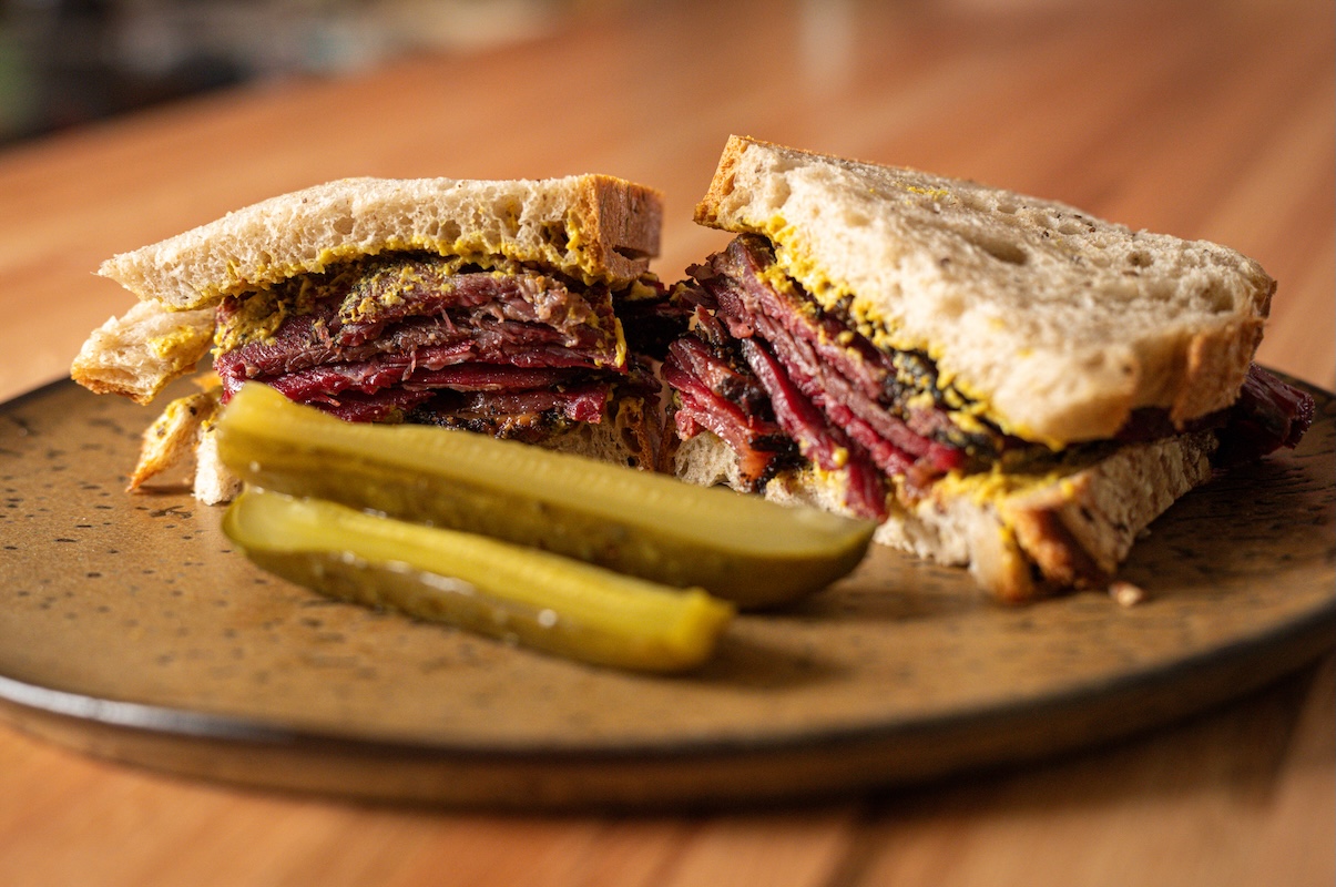 Get the first taste of chef Miles Odell's new pastrami sandwich. | Photo by Odell's Bagel