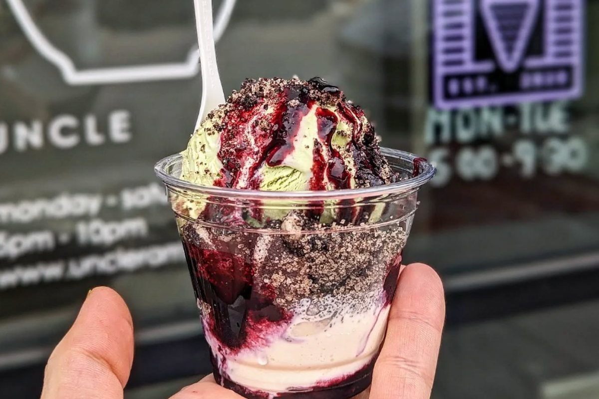 top-italian-dishes - DiningOut Cup of My Neighbor Totoreo with matcha ice cream, Oreo toffee, and blueberry jam, held up in front of the Right Cream storefront window.
