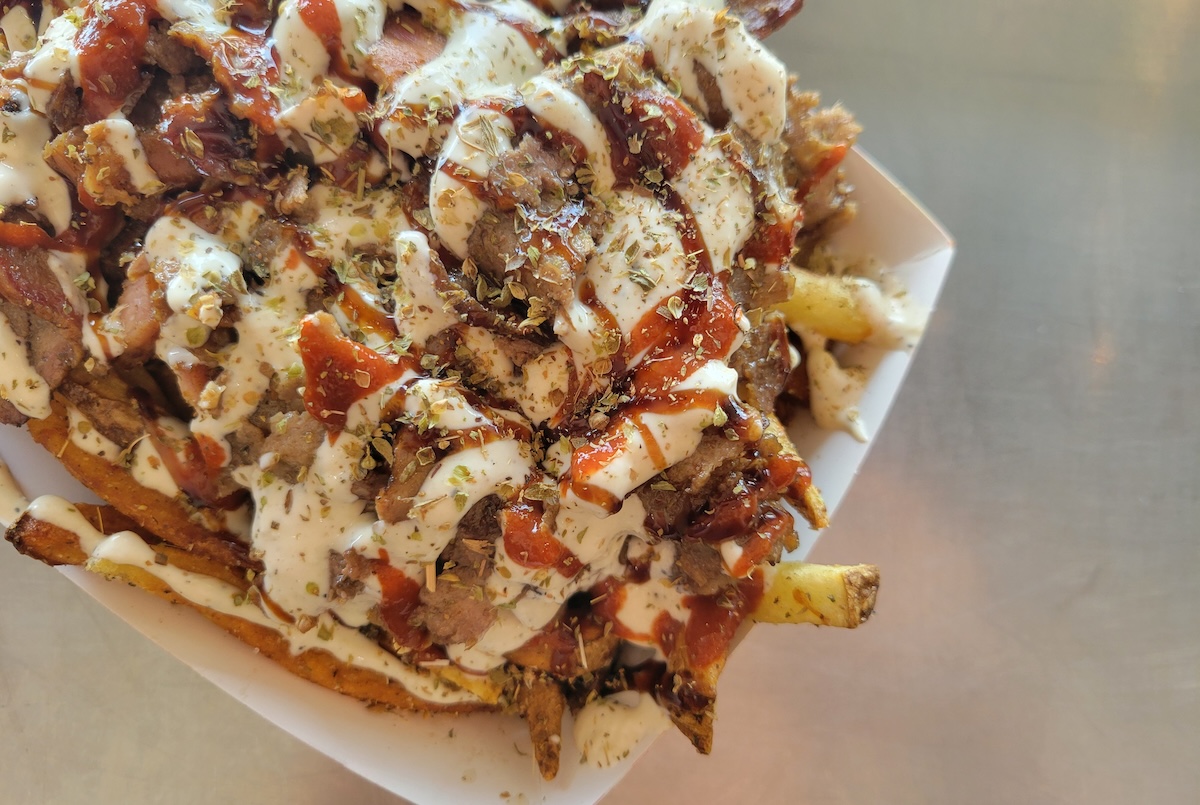 Gemma-Interior1-1 - DiningOut Beef Tallow Loaded Fries are a must-order at Samos Grill. | Photo by Linnea Covington