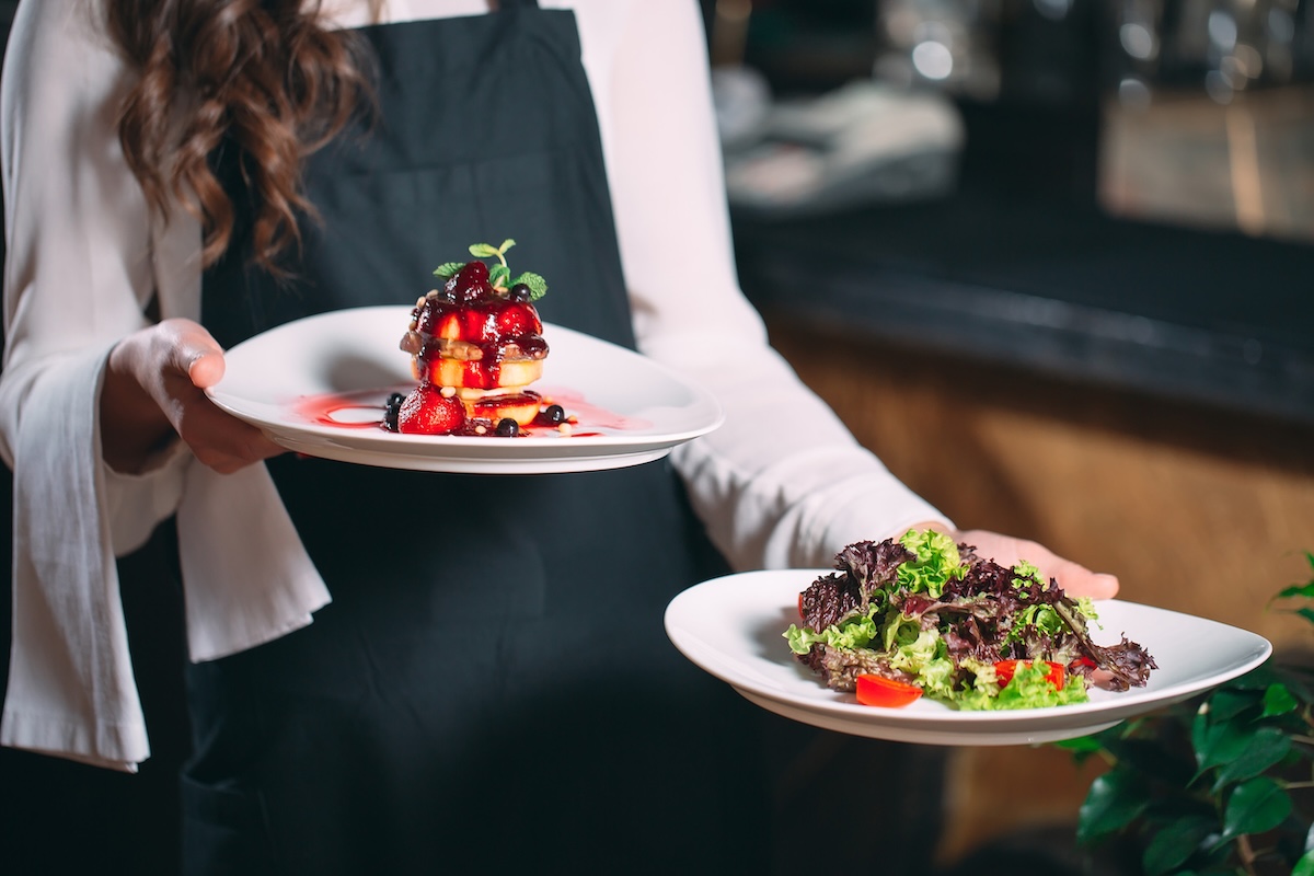 Waiter serving in motion on duty in restaurant The waiter carries dishes
stock image