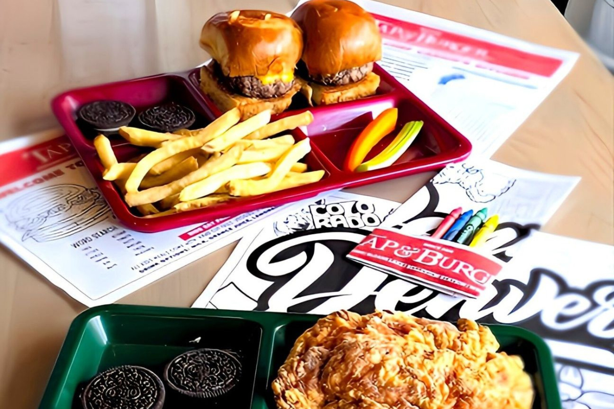 Kids meal trays with cheeseburger sliders, fried chicken, fries, cookies, and veggie sticks at Tap & Burger in Denver.