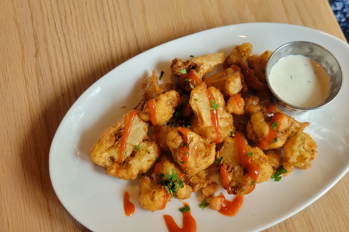 Happy hour special must-have, the Buffalo Cauliflower. | Photo by Linnea Covington