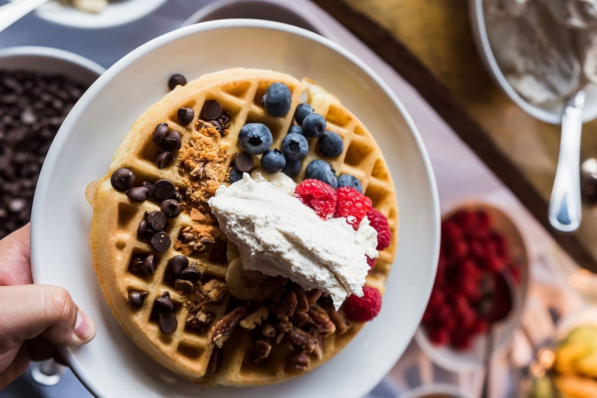 Waffle topped with whipped cream, berries, and chocolate chips at the Sunday brunch buffet at ViewHouse in Denver.
