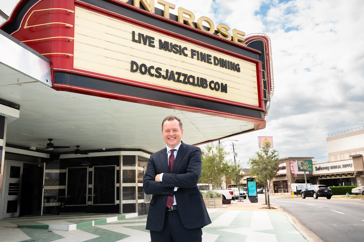 Brent "Doc" Watkins poses in front of the marquee at Doc's Houston. | Photo by Hasan Yousef