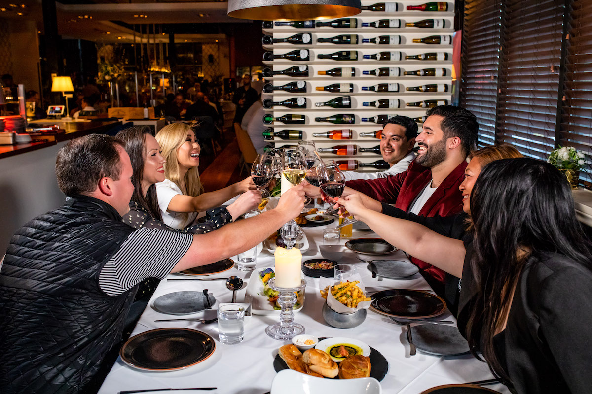 A group toasts at the chef's table at Doris Metropolitan. | Photo by Kirsten Gilliam