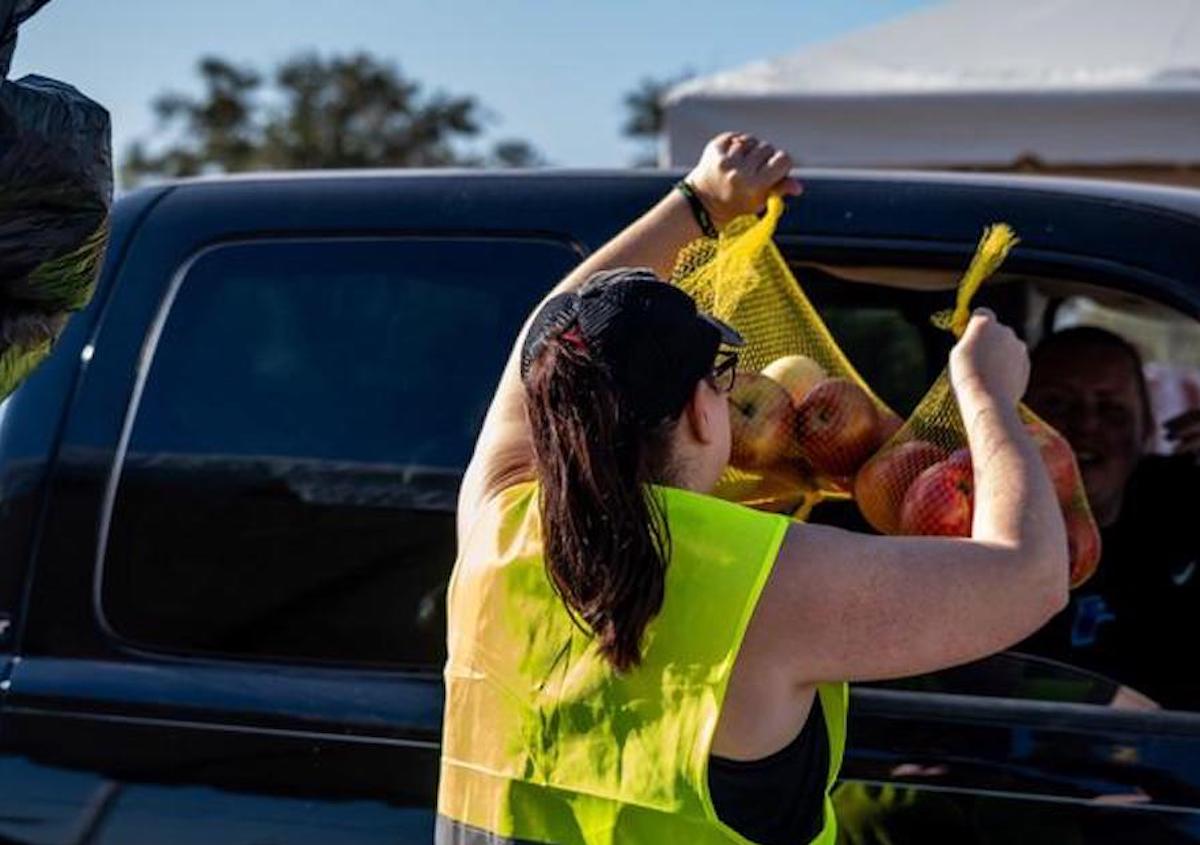 A volunteer with the Houston Food Bank distributes produce at one of the city's distribution sites. | Photo by Houston Food Bank