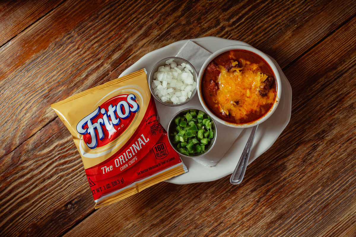 Chili with a side of Fritos, raw onions, and jalapeno at Goode Co. Armadillo Palace. | Photo by Goode Co.