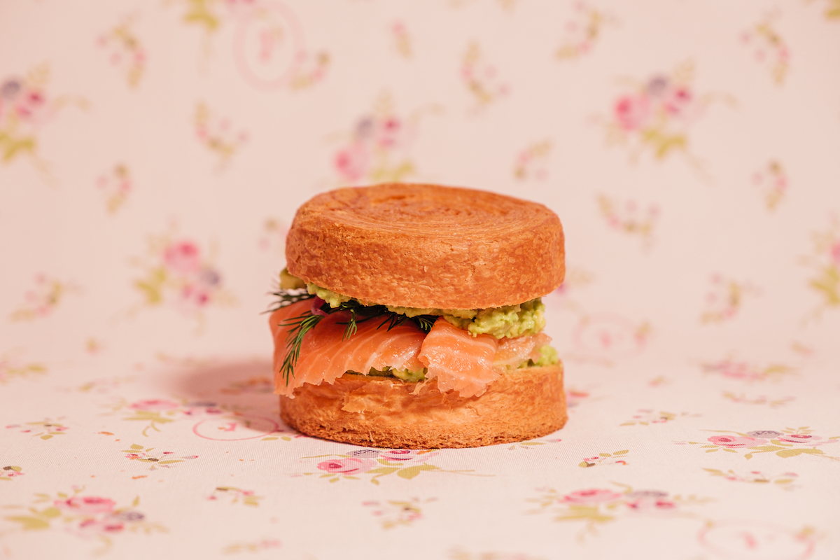 The Roll Saumon Avocat features smoked salmon, avocado, and fresh herbs tucked inside one of Café Feuillette's signature buttery "rolls," its French take on a croissant sandwich. | Photo by Café Feuillette