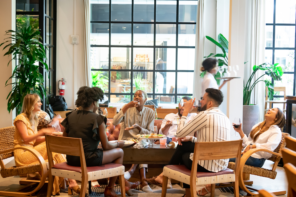 A group wines and dines in the lounge space at Sixty Vines. | Photo by Sixty Vines