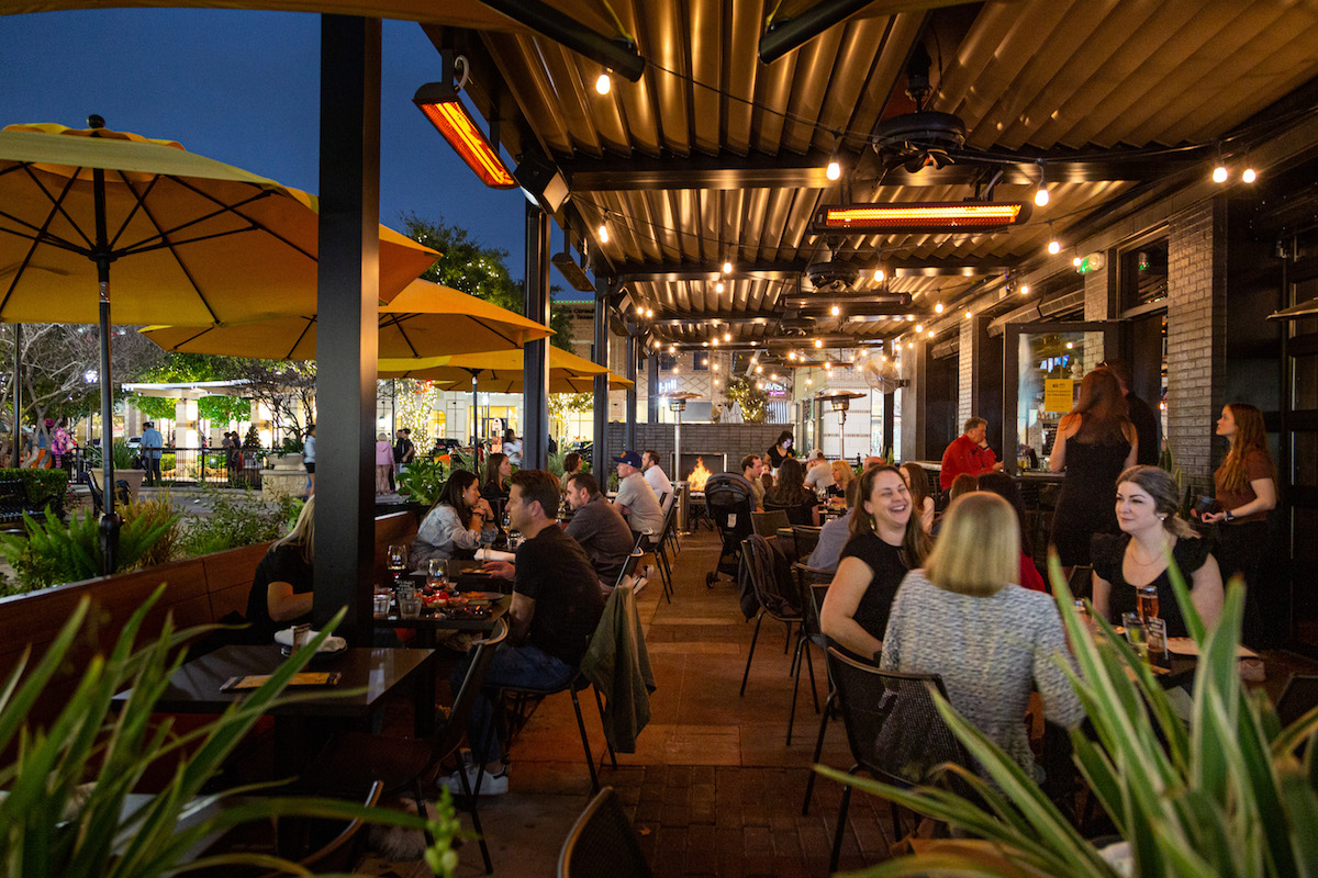 Diners sipping fireside on the patio at Postino Cinco Ranch. | Photo by Postino