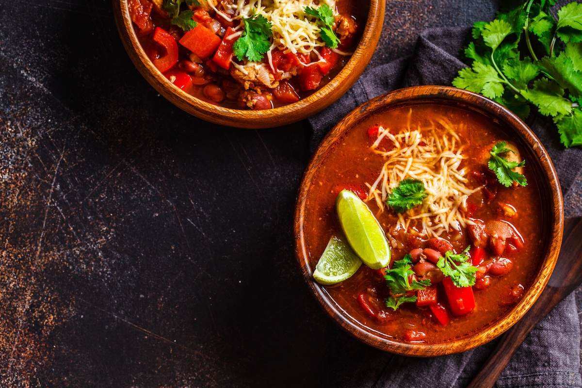 Traditional mexican bean soup with meat and cheese in a wooden bowl, top view. Mexican food concept. ID 129759239 stock photo by vaaseenaa