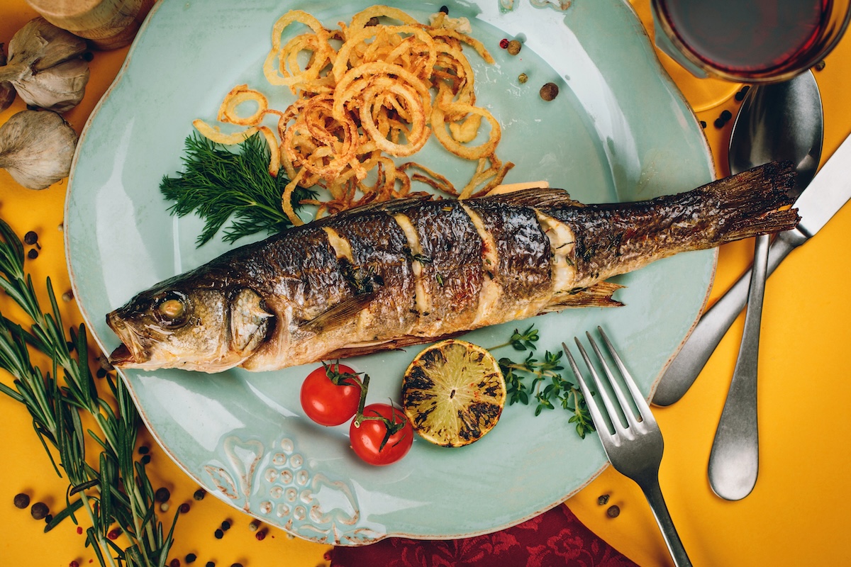 Plate of grilled fish with squid and tomatoes on a yellow background Stock Image by kaninstudio ID: 38388285