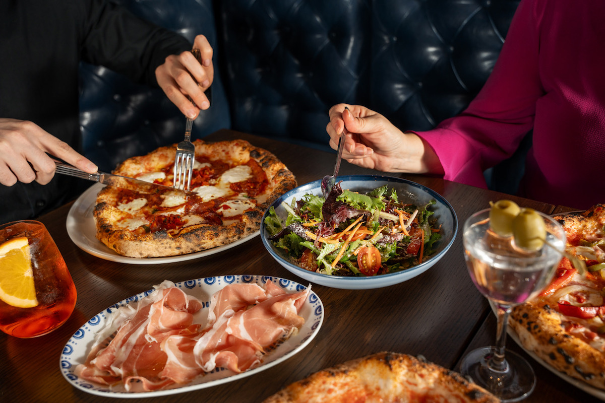 Pizzas, appetizers, and salads at Partenope. | Photo by Emily Loving Photography