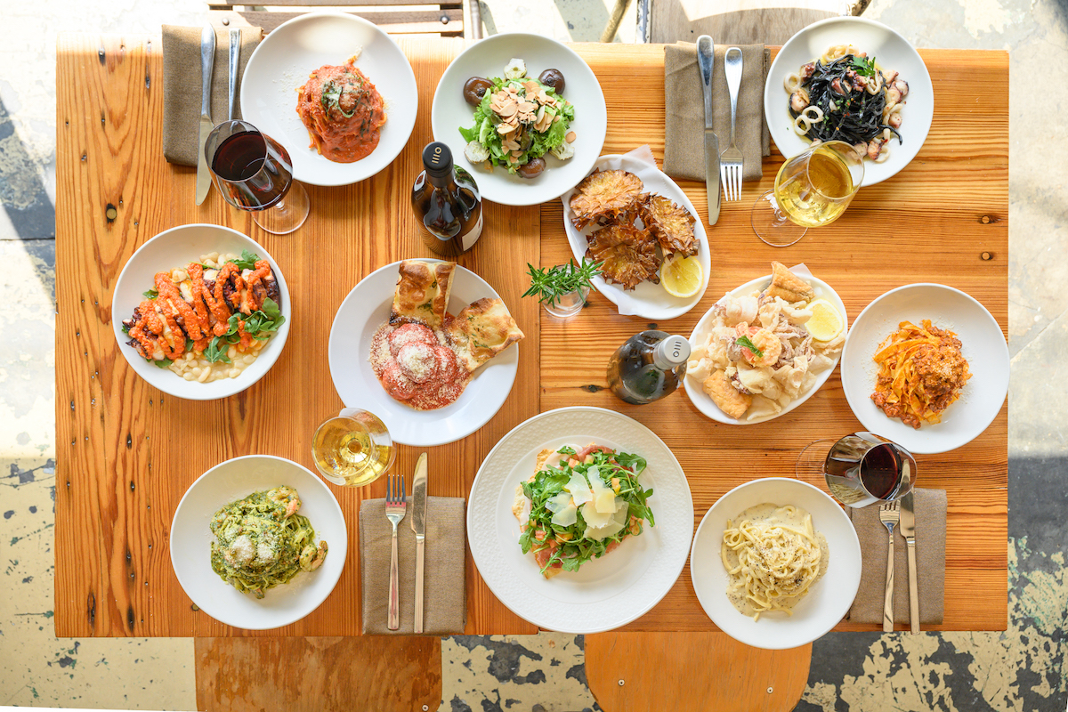 A feast of salad, pastas, mains, and wine at Storico Fresco Alimentari e Ristorante. | Photo by Storico Fresco Alimentari e Ristorante 