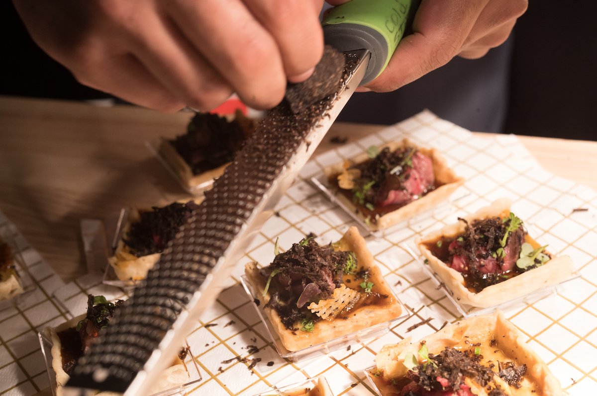 A chef competitor puts final touches on a truffle dish at the Truffle Masters. | Photo by Daniel Ortiz Photo