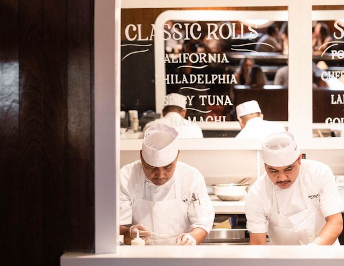 Chefs prepare sushi behind the counter at Anchor Sushi Bar. | Photo by Anchor Sushi Bar