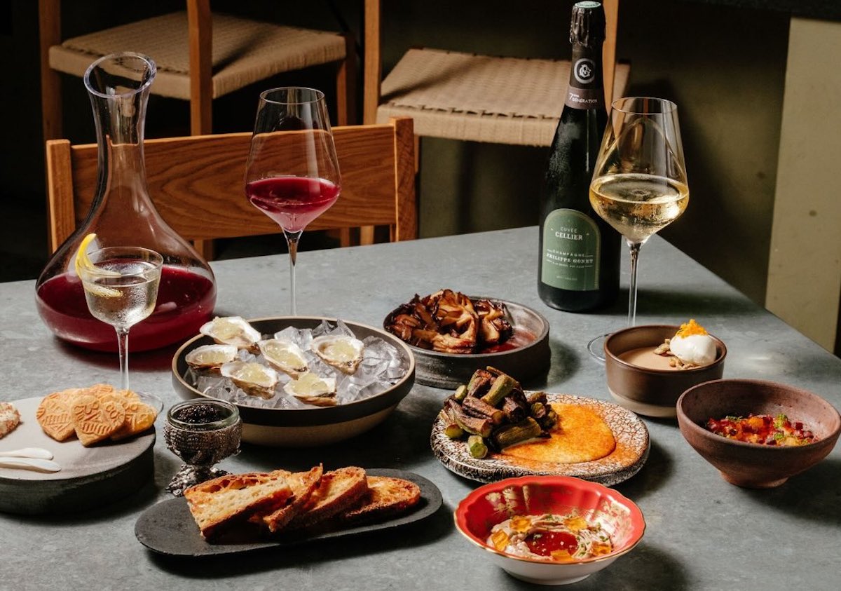 A spread of wine, raw oysters, and other starters at Baso. | Photo by Baso