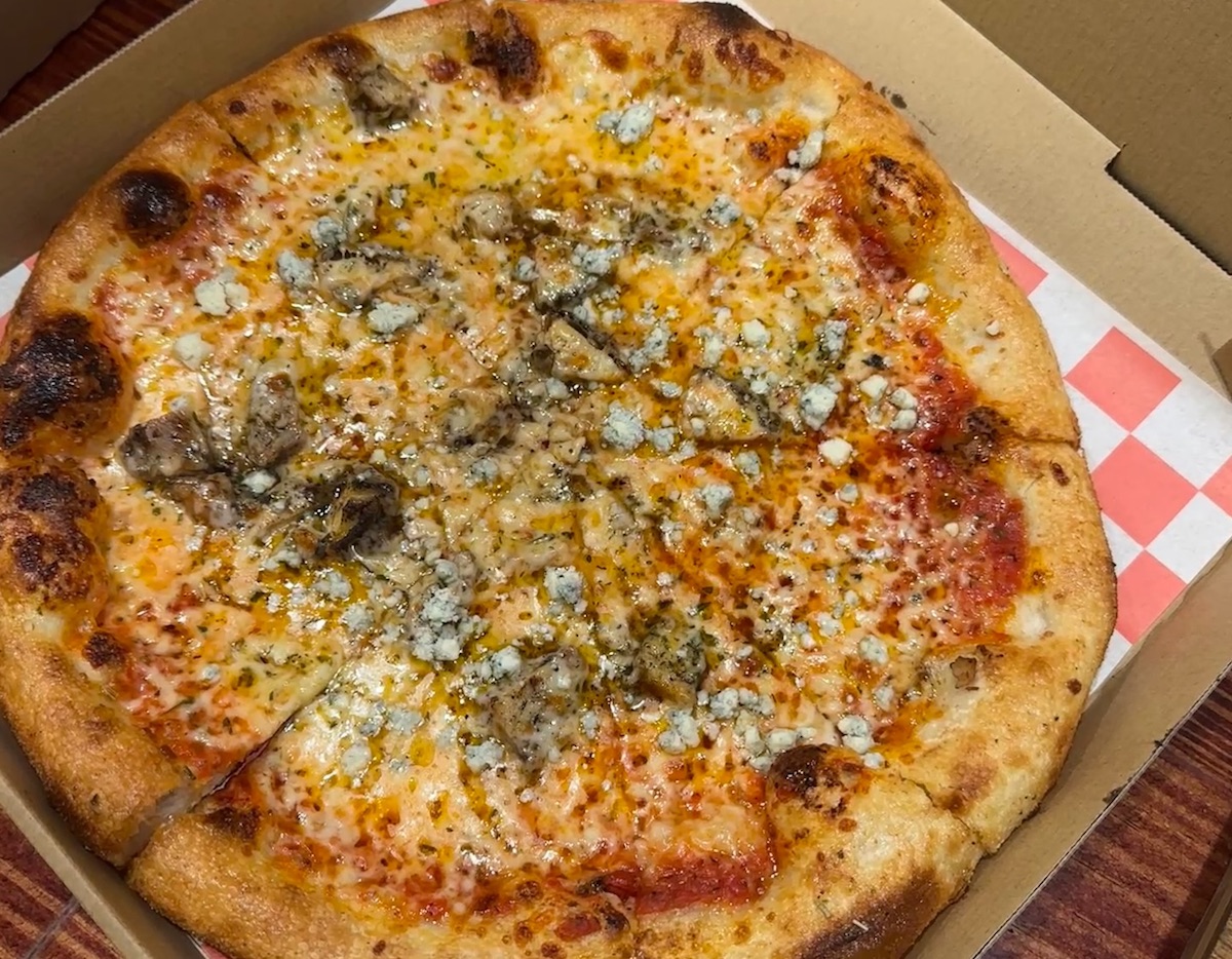 The Matey pizza, topped with jerk chicken, blue cheese, and honey at Dolo's Pizza Co. | Photo by Dolo's Pizza Co.