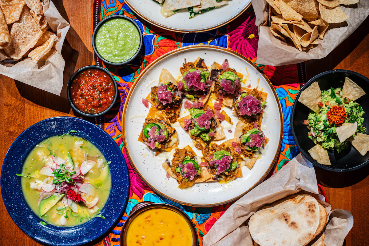 A tablespread featuring nachos Jorge at Picos. | Photo by Brandon Holmes