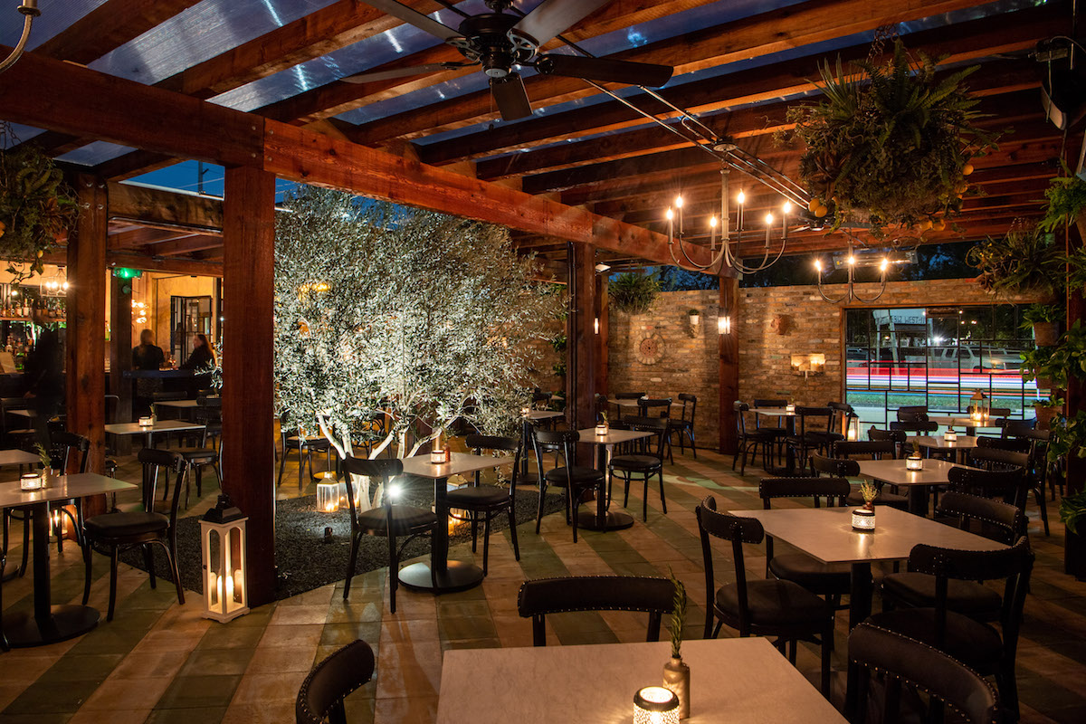 An olive tree anchors the temperature-controlled patio at Trattoria Sofia. | Photo by Michelle Watson