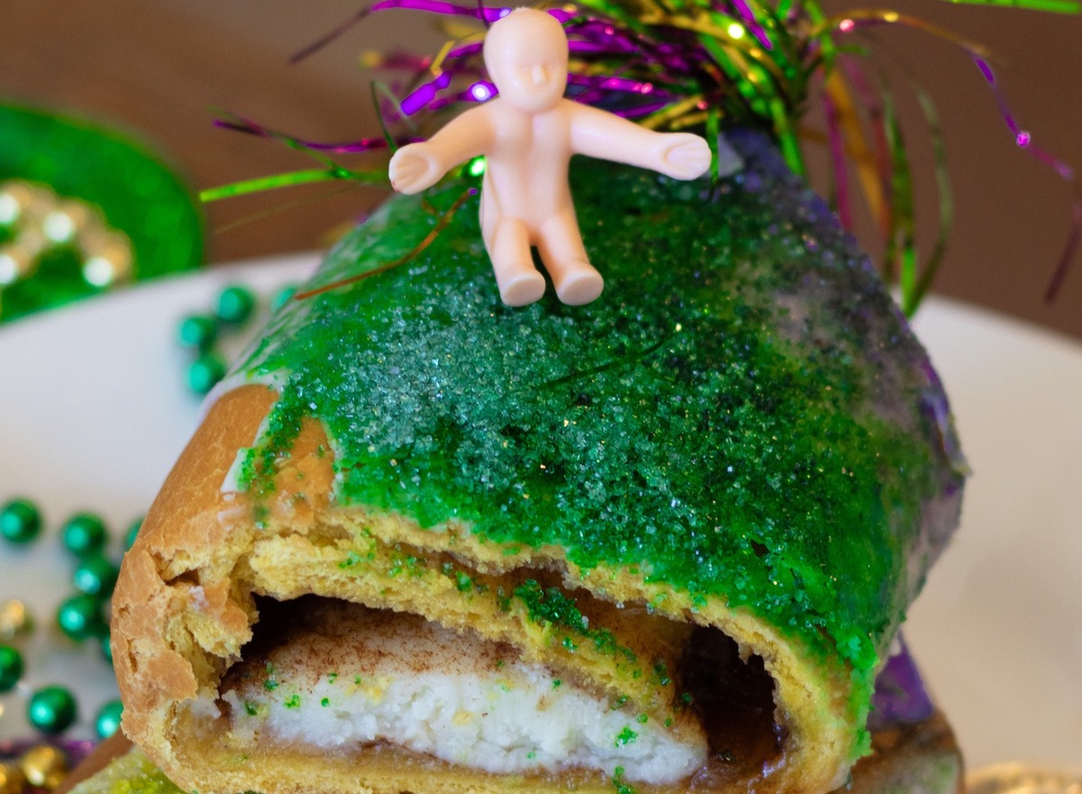 Three Brothers - DiningOut A slice of king cake topped with the signature plastic baby at Three Brothers Bakery. | Photo by Three Brothers Bakery