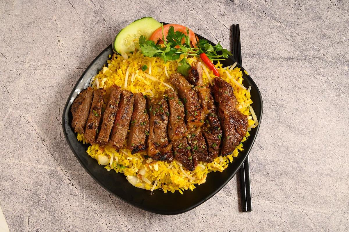 Fried rice topped with steak at Triple S pho & Grill. | Photo by Triple S Pho & Grill