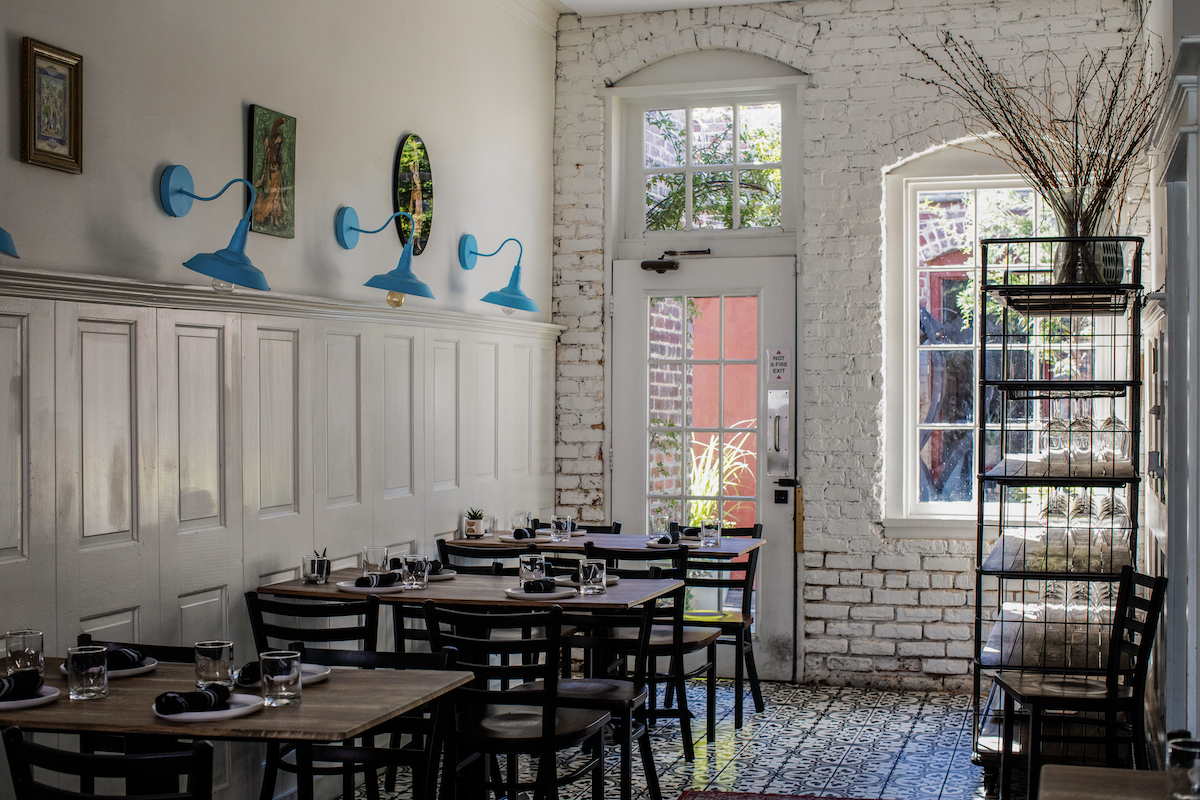 The quaint and cozy dining room with pops of color at Kitty Dare. | Photo by Heidi Harris