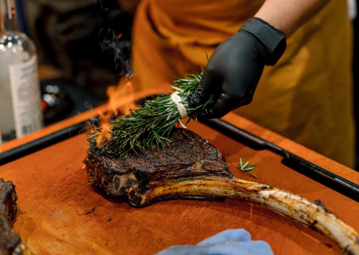 Toro Toro's flaming tomahawk at the 2026 Rodeo Uncorked! Best Bites Roundup and Competition at NRG Center. | Photo by HLSR
