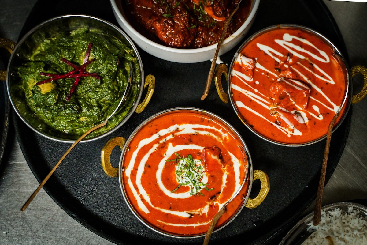 Butter chicken, paneer tikka, and saag paneer at Blue India. | Photo by Blue India