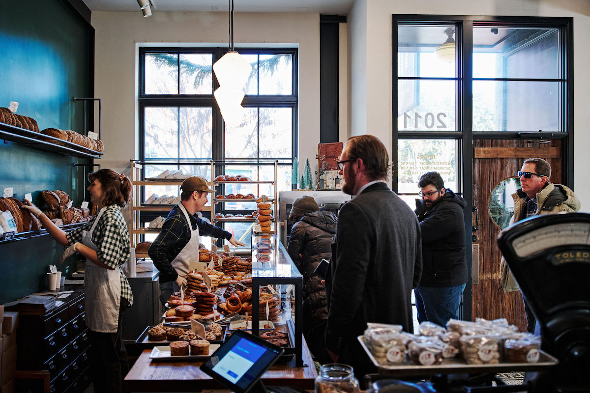 Katie Orton (left) and Eli Franco (right) take orders on a busy Friday morning at Evergreen Butcher and Baker. | Photo by Evergreen Butcher and Baker