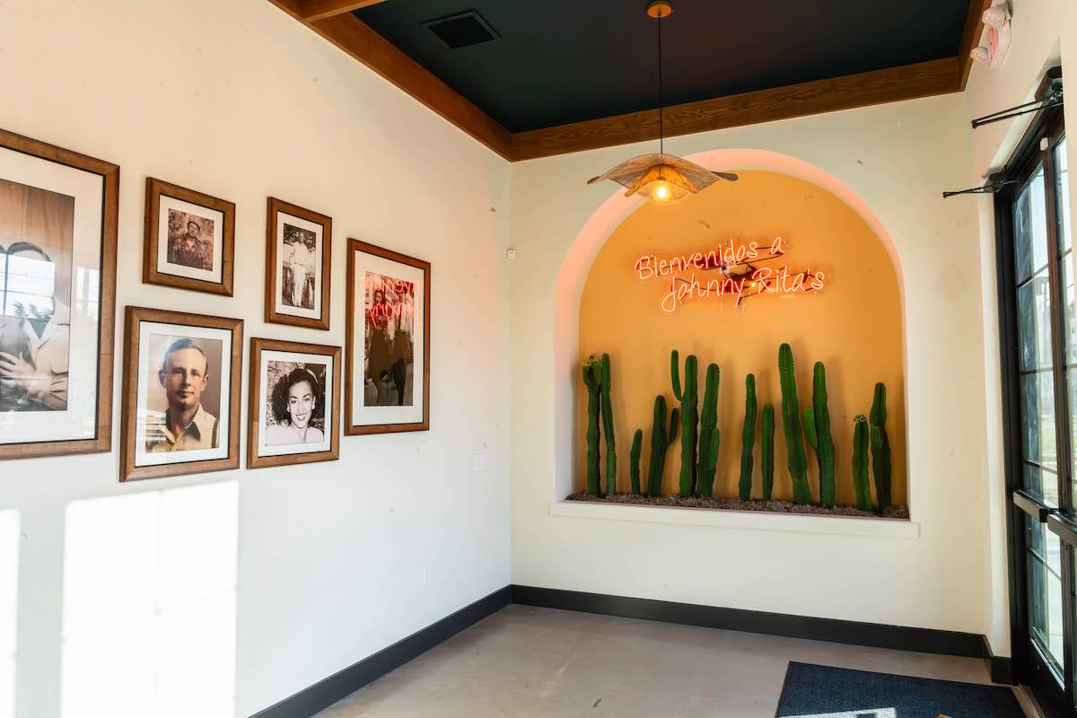 Diners are greeted with a gallery wall of family photos at the entrance of Johnny Ritas. | Photo by Hasan Yousef