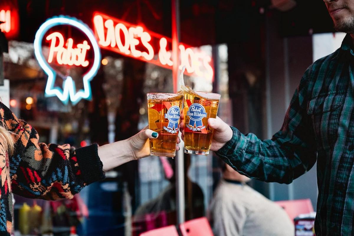 A beer cheers outside Moe's and Joe's. | Photo by Moe's and Joe's