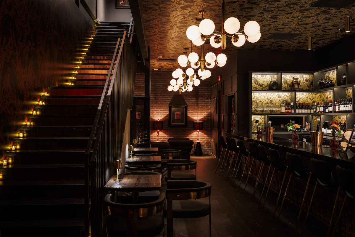A staircase leads guests to the downstairs bar area at Night Rooster. | Photo by Samantha Marie Photography