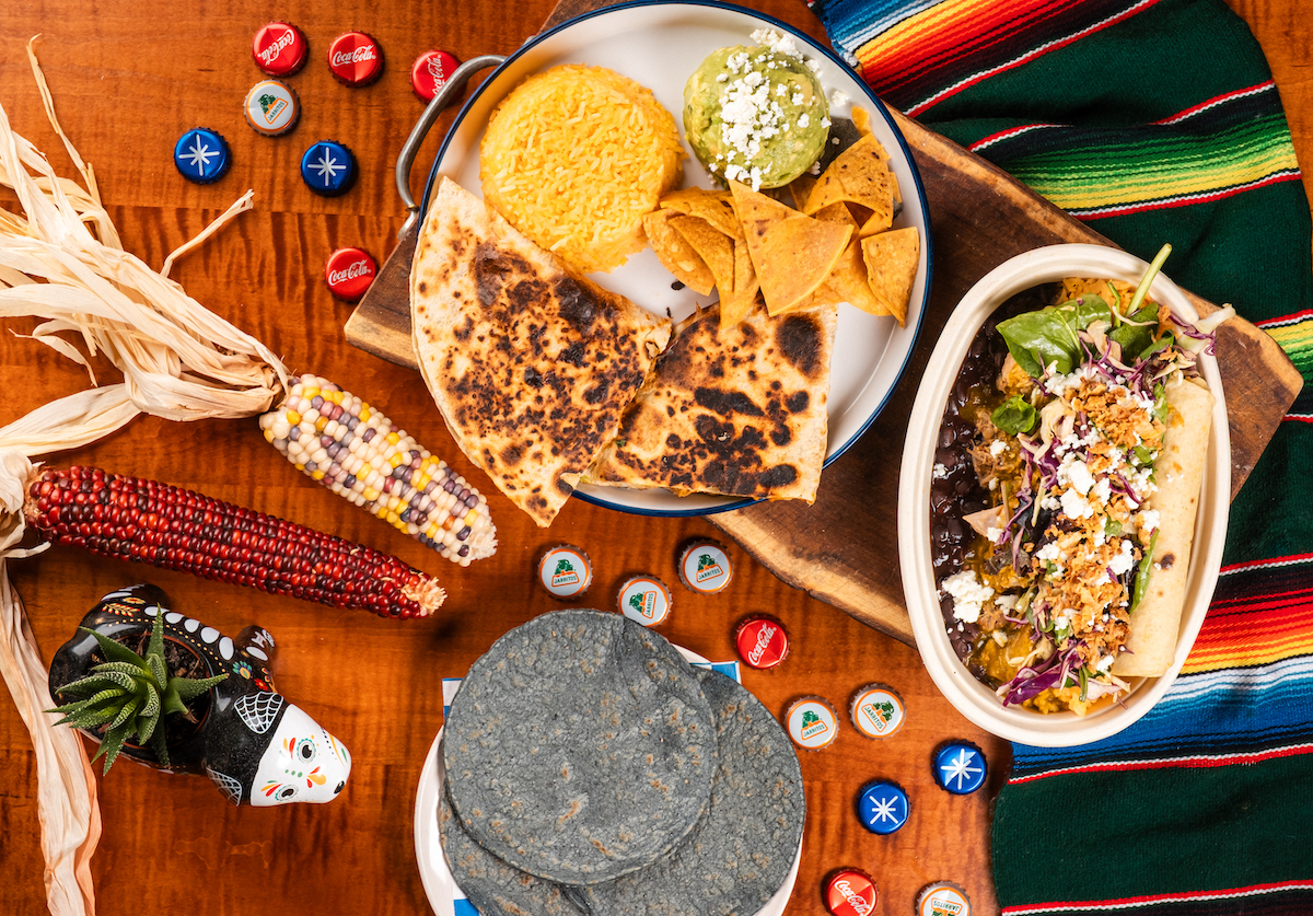 Signature blue corn tortillas showcased alongside dishes at Papalo Taqueria. | Photo by the Finn