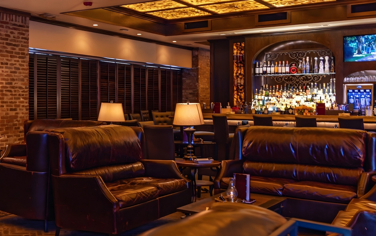 Red Phone Booth - DiningOut Leather seating and dim lighting set the mood at Red Phone Booth. | Photo by Red Phone Booth