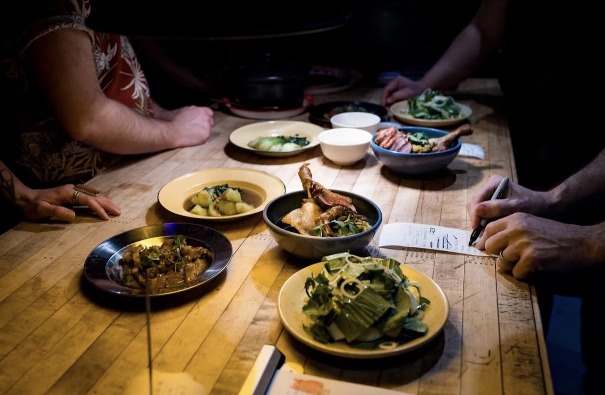 A variety of dishes hit the pass at Talat Market. | Photo by Dustin Chambers 