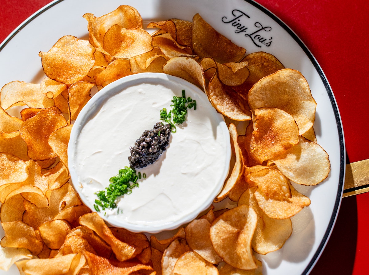 House-made chips and ostera caviar with French onion crème at Tiny Lou's. | Photo by Heidi Harris