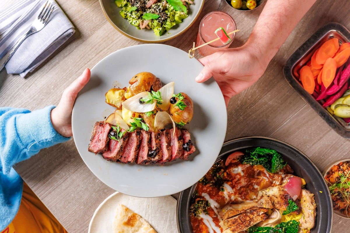 Share an order of grilled NY strip steak and sides. | Photo courtesy of Ash'Kara