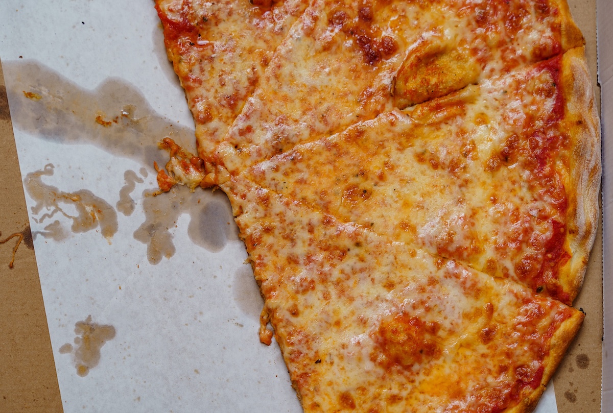 A real tasty cheese pizza from a restaurant on cardboard - DiningOut A real tasty cheese pizza from a restaurant on cardboard. ID: 122100254