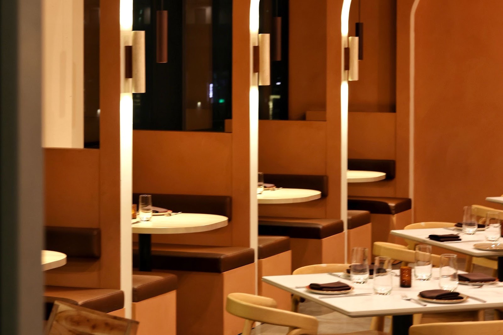 An arched ceiling creates intimate dining nooks | Photo by Austin Carson